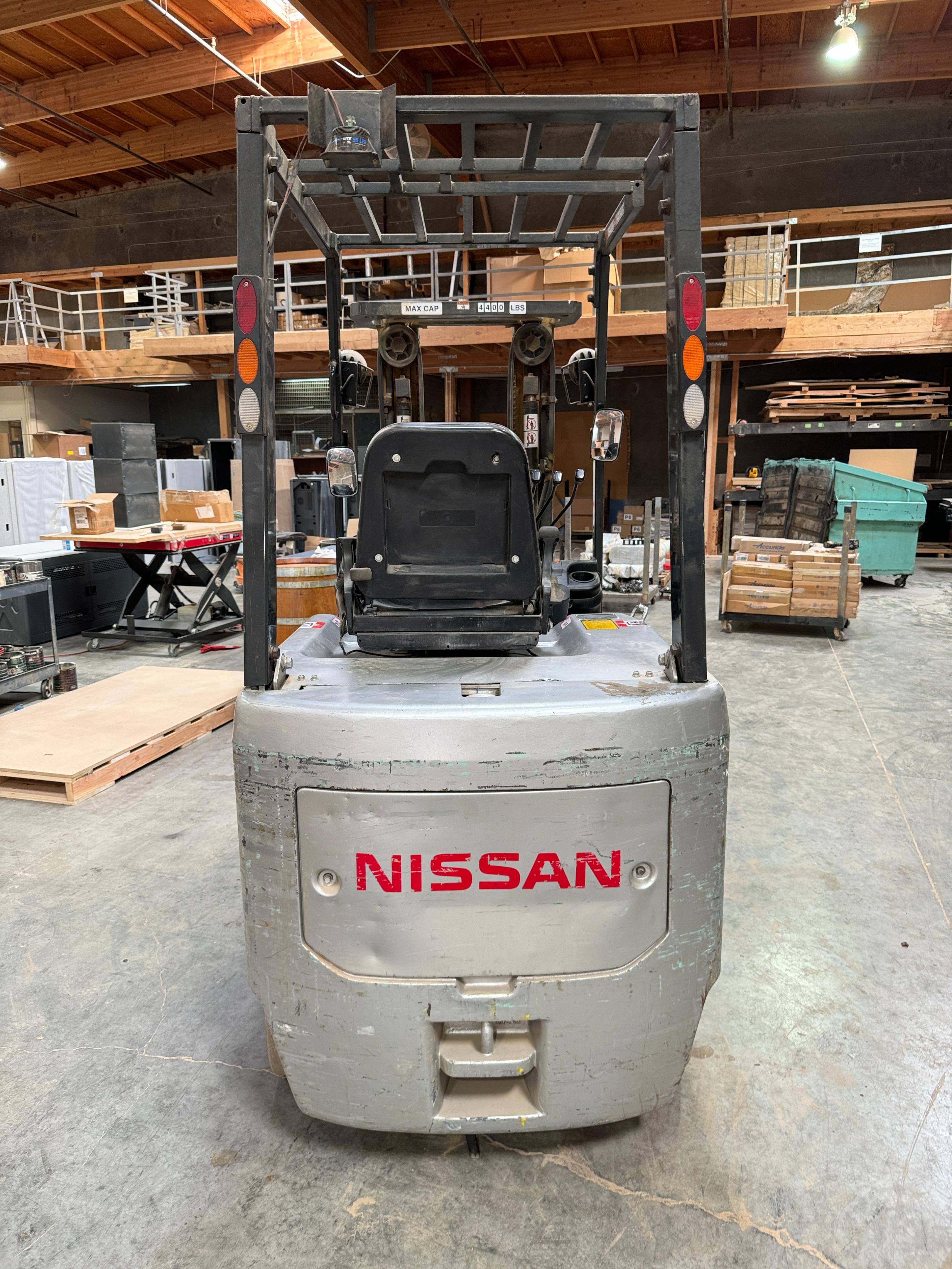 NISSAN ELECTRIC FORKLIFT, MODEL CP1B2L25S, 4,000 LB CAPACITY, 3-STAGE MAST, SIDE SHIFT, SOLID TIRES, 4' FORKS, LOAD LIGHTS, APPROX. 11,751 HOURS, S/N CP1B2-000219, W/ POWERHOUSE BATTERY CHARGER, (DELAYED PICKUP UNTIL FEBRUARY 20)-36