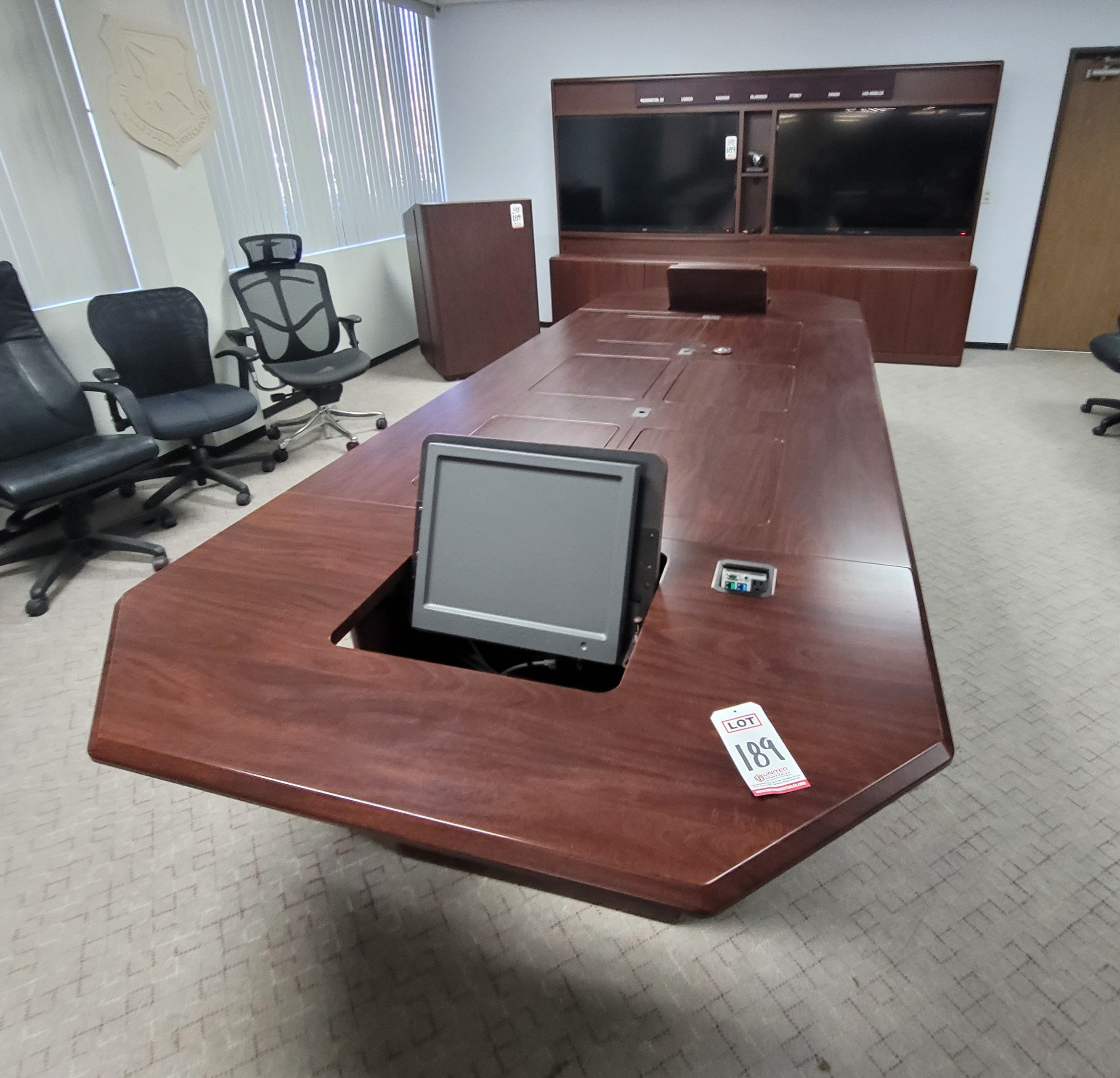 LOT - CONFERENCE ROOM GROUPING: CONFERENCE TABLE W/ FLIP-PANELS FOR MONITORS, AUDIO VIDEO CABINET W/ (2) 65" LCD SCREENS AND DIGITAL TIME ZONE CLOCK, FREESTANDING PODIUM, COLOR: MAHOGANY-189