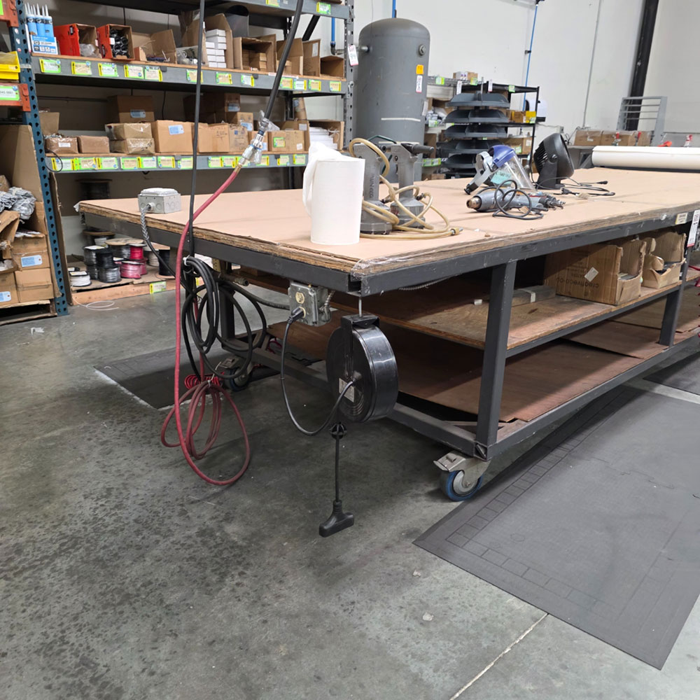STEEL TABLE ON CASTERS W/ 14' X 5' PLYWOOD TOP, 37" TOP HT, CONTENTS NOT INCLUDED-177