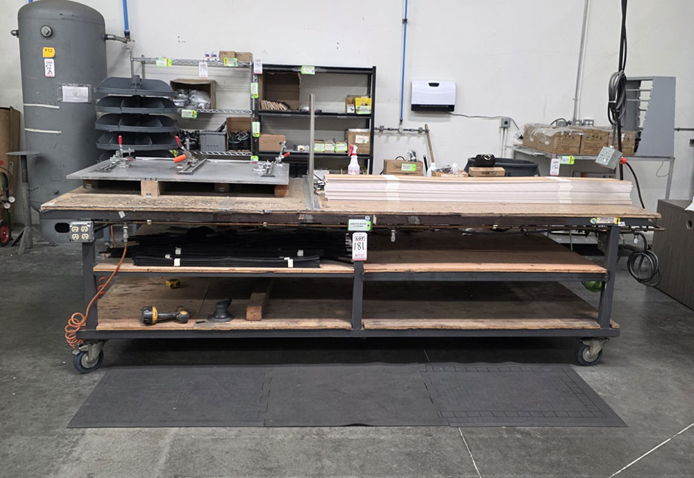 STEEL TABLE ON CASTERS W/ 11' X 4' PLYWOOD TOP, 37" TOP HT, CONTENTS NOT INCLUDED-181