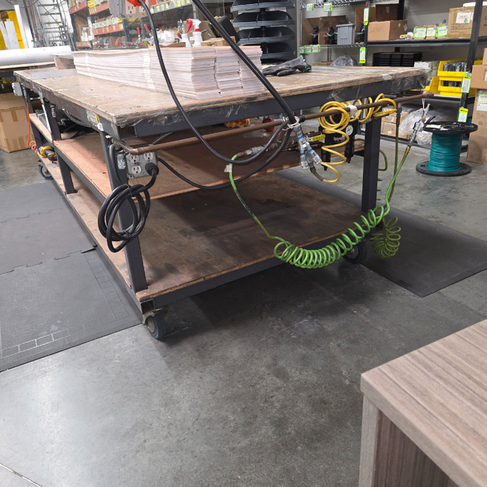 STEEL TABLE ON CASTERS W/ 11' X 4' PLYWOOD TOP, 37" TOP HT, CONTENTS NOT INCLUDED-181