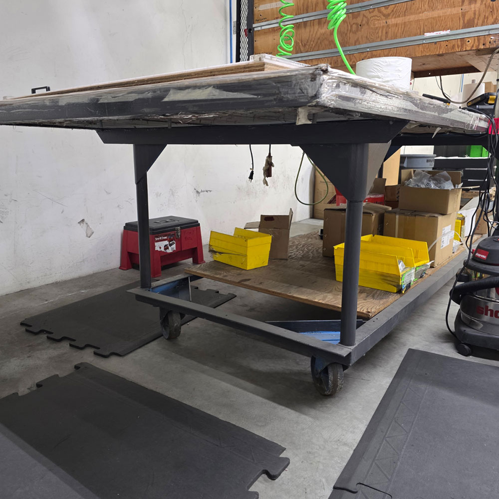 STEEL TABLE ON CASTERS W/ 12' X 4' WOOD TOP, 37" TOP HT, CENTER STORAGE, CONTENTS NOT INCLUDED-198