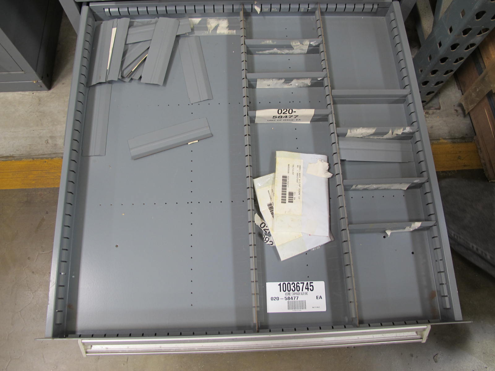STANLEY VIDMAR CABINET, 11 DRAWER, TO INCLUDE: LIGHT BULBS, CHECK VALVES, PNUEMATIC TIME DELAY ATTACHMENTS, DEFLECTORS, CAMERA LENS, RECTIFIER, MISC MODULES, PRESSURE GAUGE, COMPRESSOR PISTONS. LOCATED AT W-50 . LOADING AND HANDLING FEE $25-372