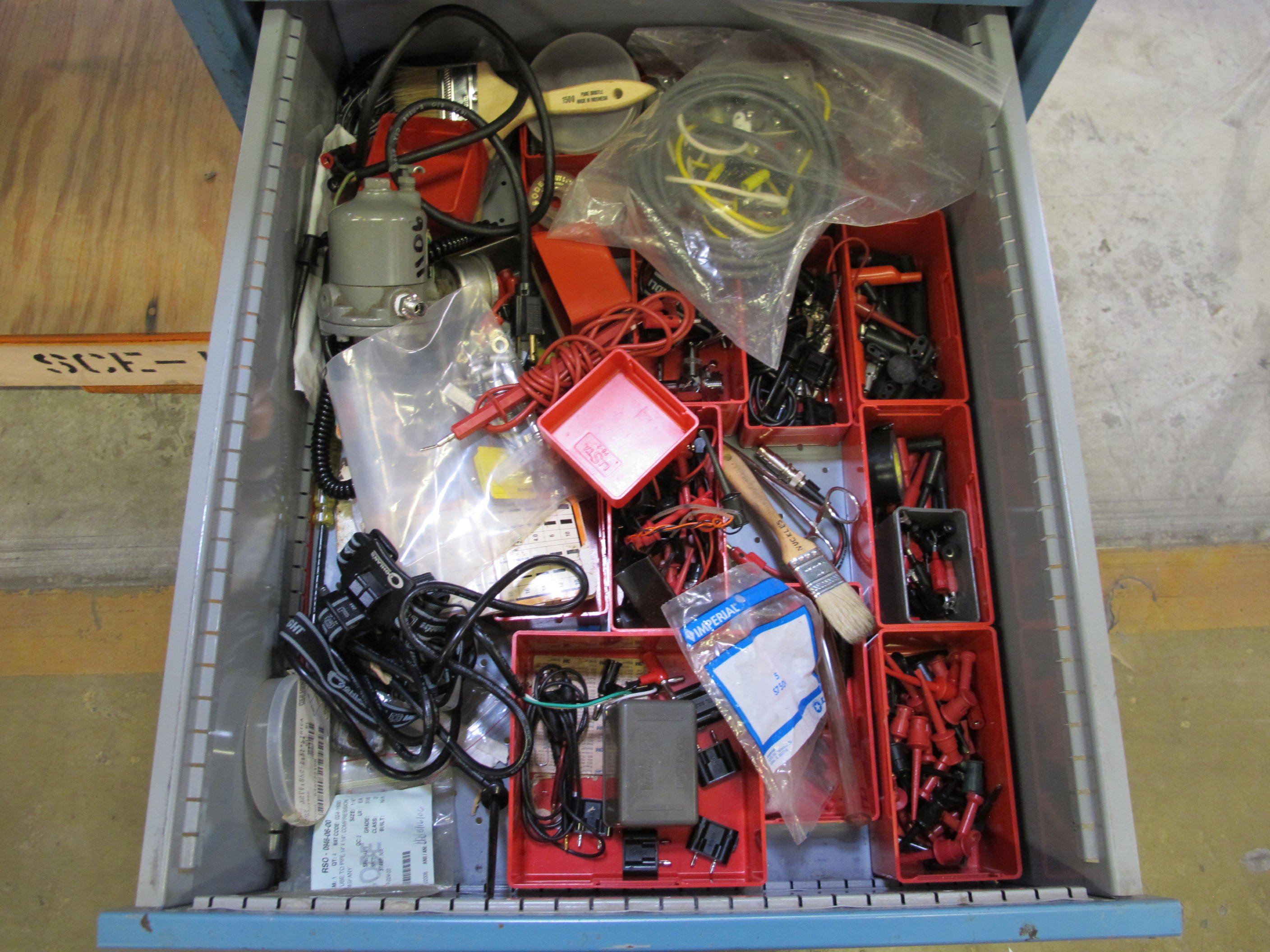 LISTA INDUSTRIAL WORK DESK, BUTCHER BLOCK TABLE TOP 48"L X 30"W, SHELF, 4 DRAWER CABINET WITH CONTENTS TO INCLUDE: MISC. OFFICE SUPPLIES, CABLES, SAFETY GLASSES, BRUSHES, ELECTRIC TESTING WIRE. LOADING & HANDLING $15-1691