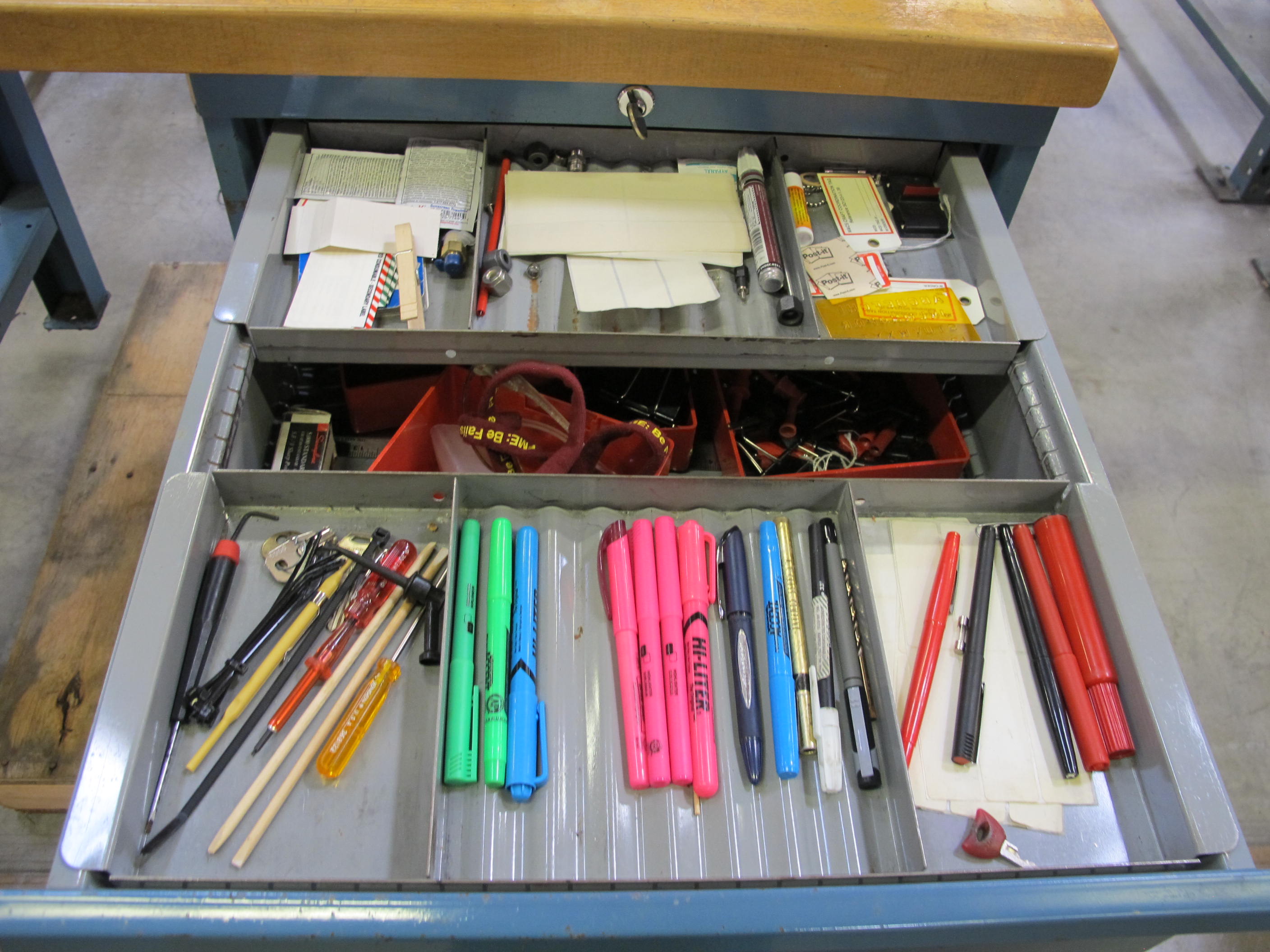 LISTA INDUSTRIAL WORK DESK, BUTCHER BLOCK TABLE TOP 48"L X 30"W, SHELF, 4 DRAWER CABINET WITH CONTENTS TO INCLUDE: MISC. OFFICE SUPPLIES, CABLES, SAFETY GLASSES, ELECTRIC TESTING WIRE. LOADING & HANDLING $15-1692