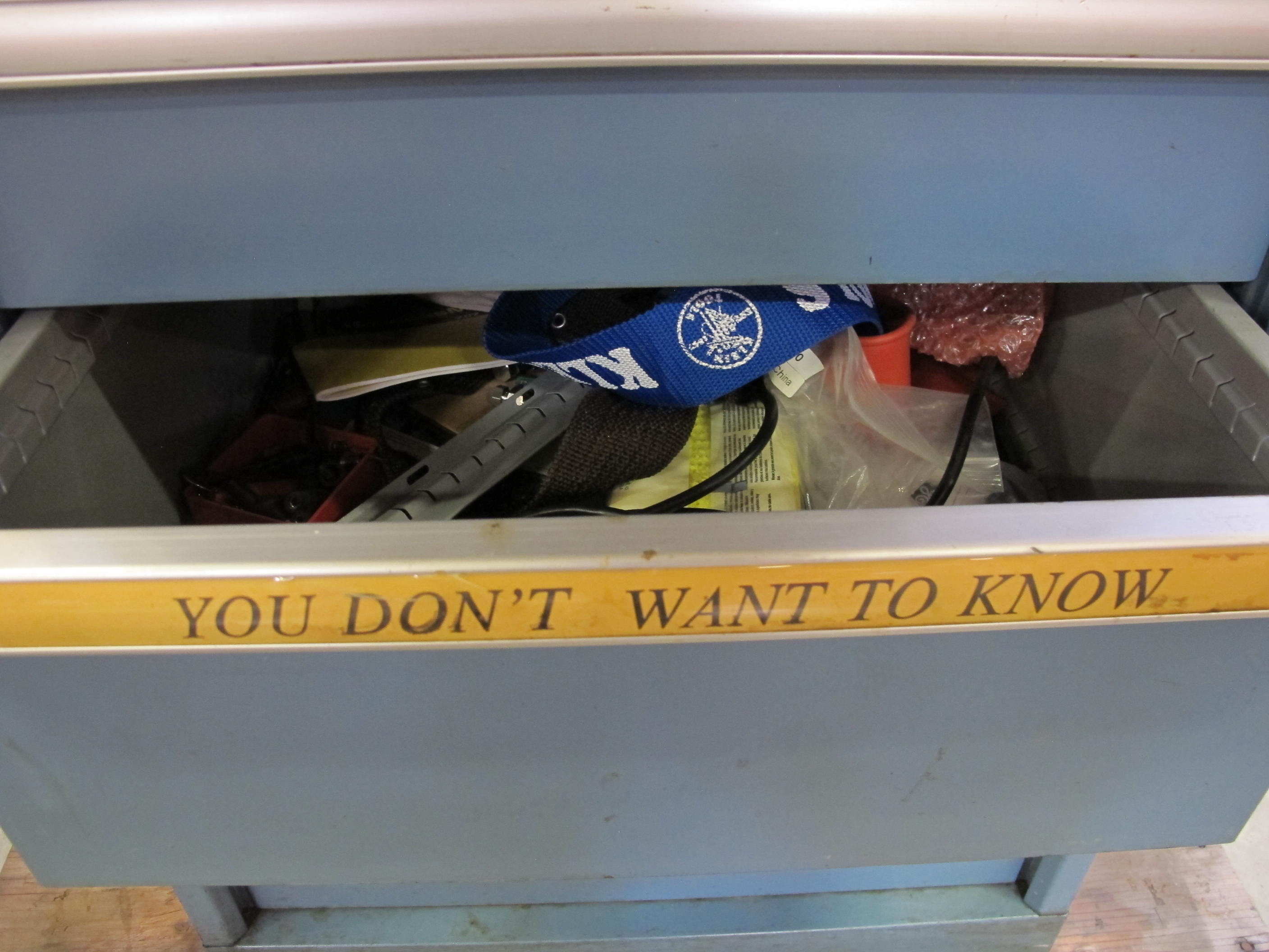 LISTA INDUSTRIAL WORK DESK, BUTCHER BLOCK TABLE TOP 60"L X 30"W, 5 DRAWER CABINET WITH CONTENTS TO INCLUDE: MISC. OFFICE SUPPLIES, EAR PLUGS, SAFETY GLASSES, ELECTRIC TEST WIRE, . LOADING & HANDLING $15-1693