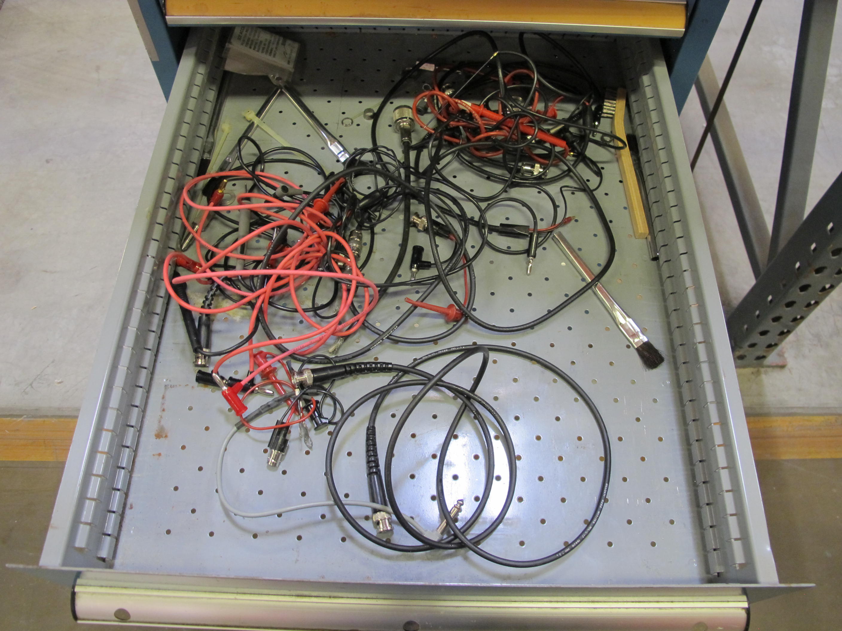 LISTA INDUSTRIAL WORK DESK, BUTCHER BLOCK TABLE TOP 60"L X 30"W, 5 DRAWER CABINET WITH CONTENTS TO INCLUDE: MISC. OFFICE SUPPLIES, TEST WIRE, EAR MUFFS. LOADING & HANDLING $15-1694