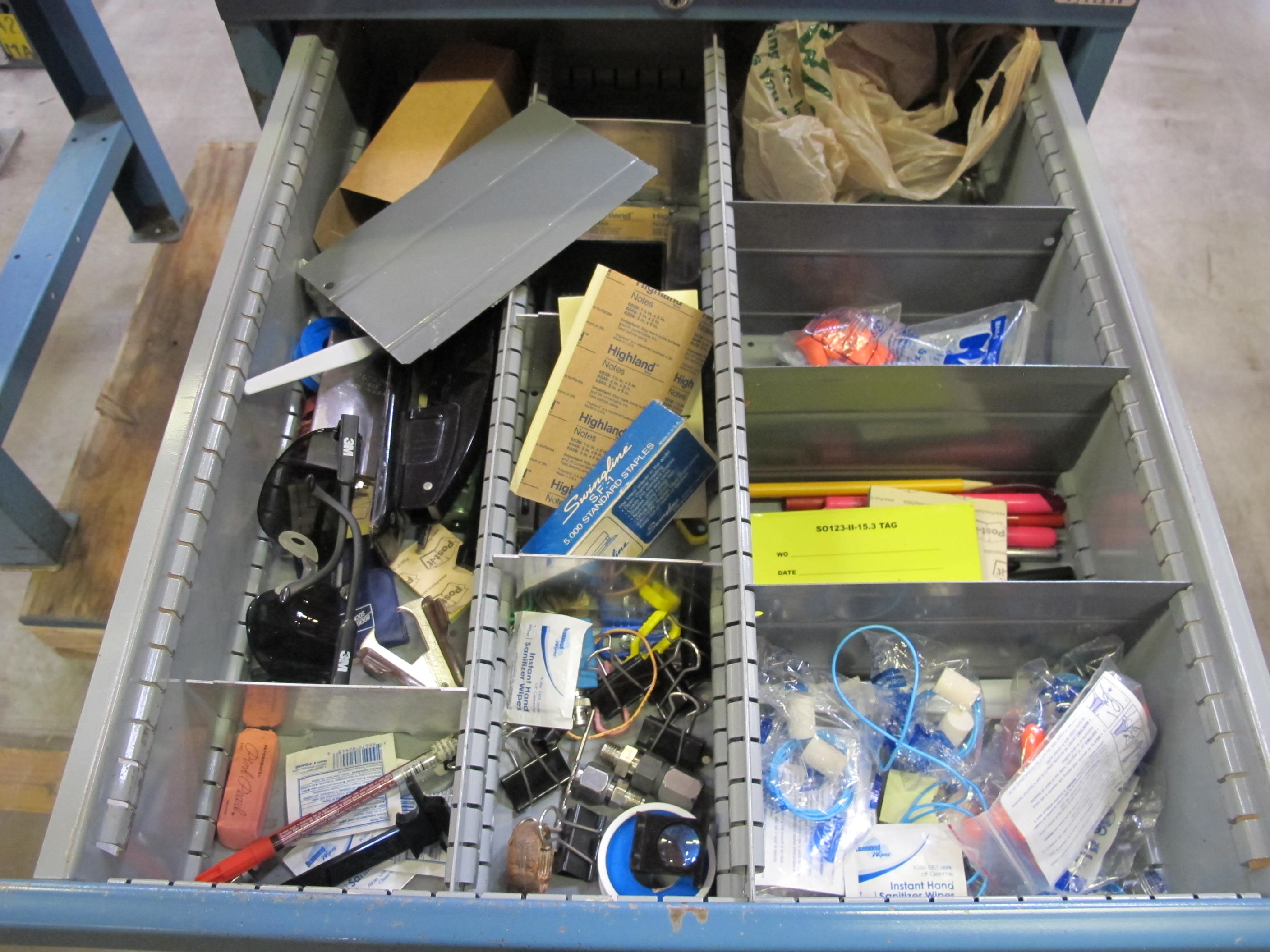 LISTA INDUSTRIAL WORK DESK, BUTCHER BLOCK TABLE TOP 48"L X 30"W, SHELF, 4 DRAWER CABINET WITH CONTENTS TO INCLUDE: EAR PLUGS, MISC. OFFICE SUPPLIES, WIRING, PRECISION SCREWDRIVERS, WATERPROOF RAINWEAR 3 PIECE SUIT. LOADING & HANDLING $15-1696