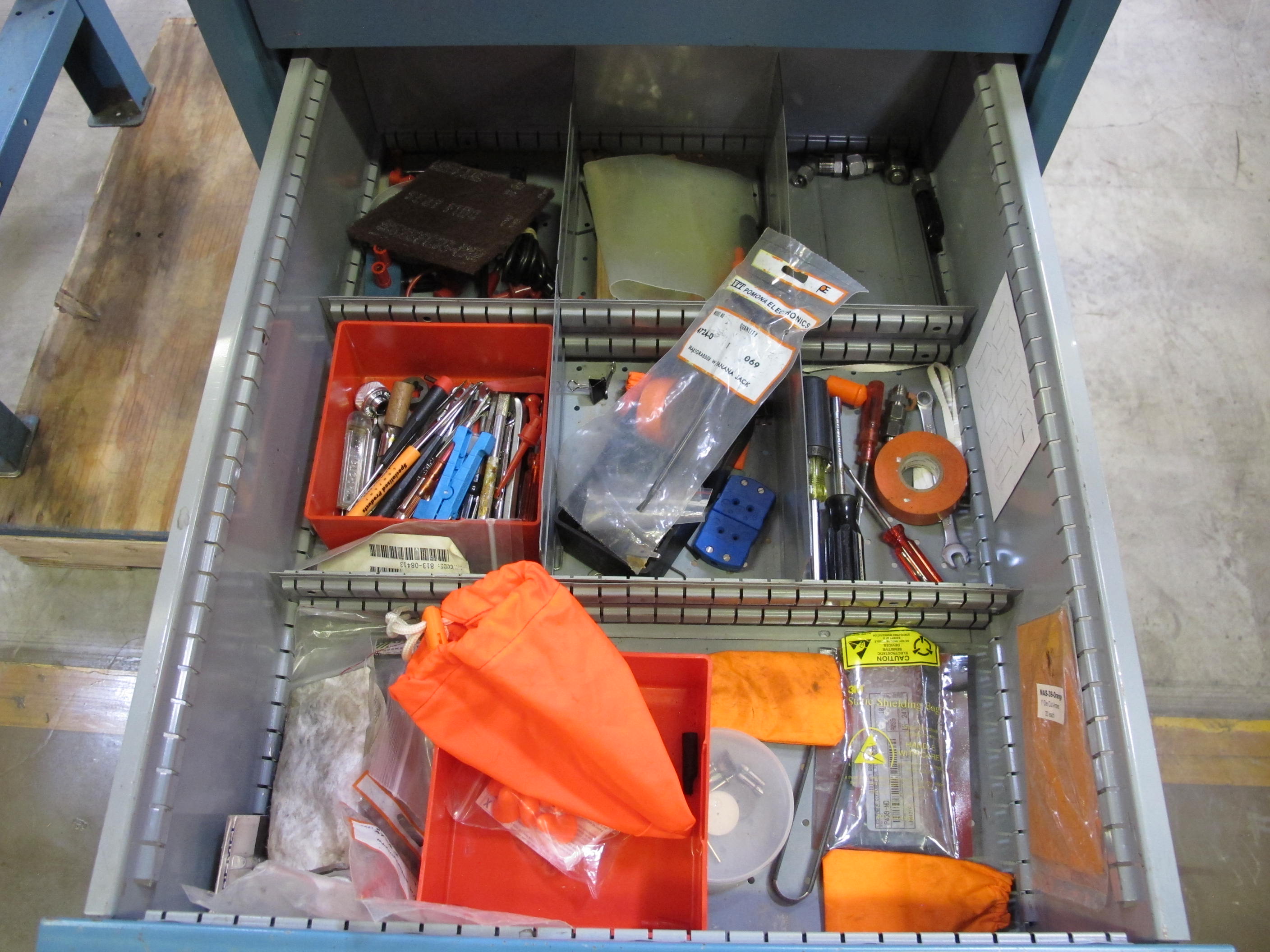 LISTA INDUSTRIAL WORK DESK, BUTCHER BLOCK TABLE TOP 48"L X 30"W, SHELF, 4 DRAWER CABINET WITH CONTENTS TO INCLUDE: EAR PLUGS, MISC. OFFICE SUPPLIES, WIRING, PRECISION SCREWDRIVERS, WATERPROOF RAINWEAR 3 PIECE SUIT. LOADING & HANDLING $15-1696