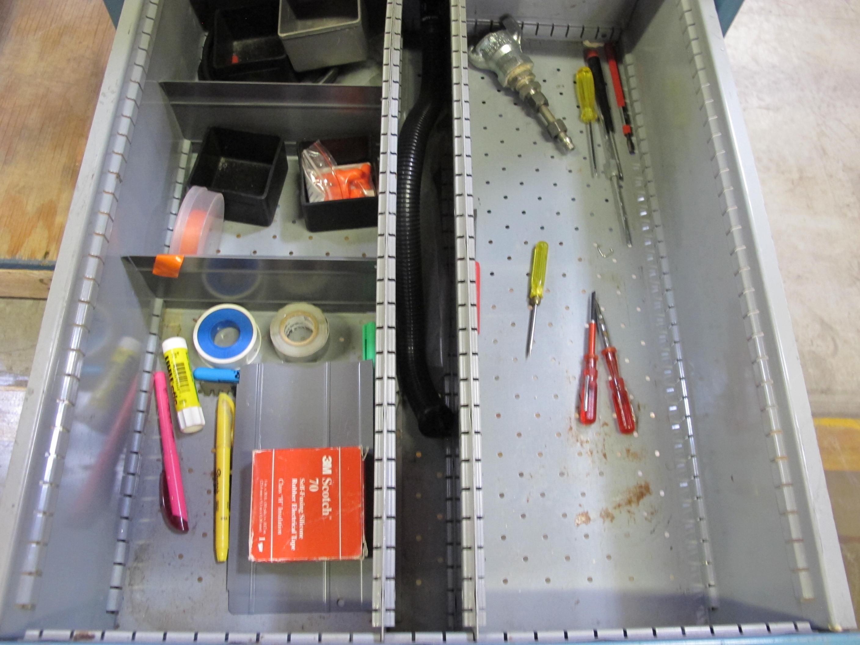 LISTA INDUSTRIAL WORK DESK, BUTCHER BLOCK TABLE TOP 48"L X 30"W, SHELF, 4 DRAWER CABINET WITH CONTENTS TO INCLUDE: EAR PLUGS, MISC. OFFICE SUPPLIES, WIRING, PRECISION SCREWDRIVERS, WATERPROOF RAINWEAR 3 PIECE SUIT. LOADING & HANDLING $15-1696