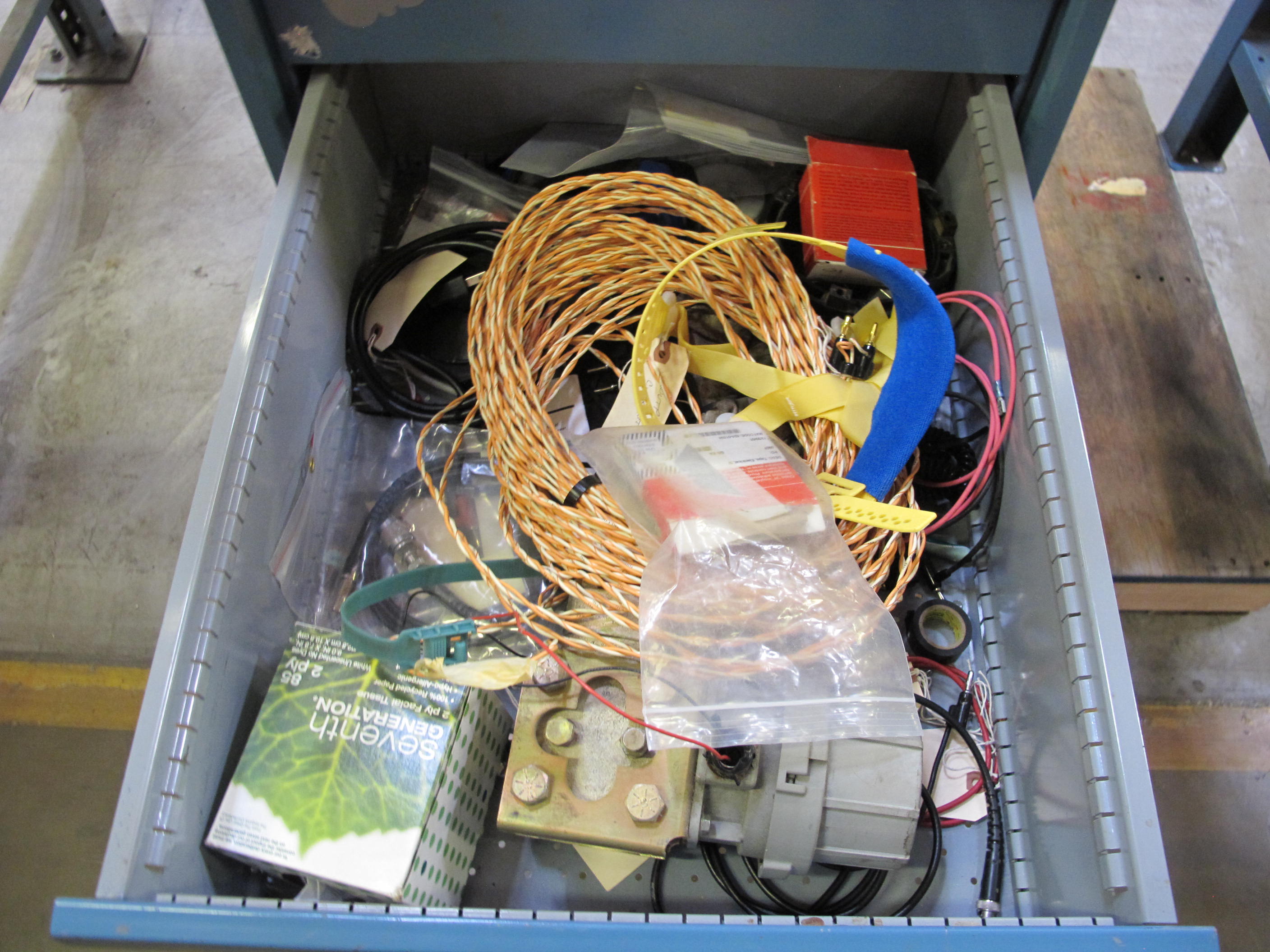 LISTA INDUSTRIAL WORK DESK, BUTCHER BLOCK TABLE TOP 48"L X 30"W, 4 DRAWER CABINET WITH CONTENTS TO INCLUDE: EAR PLUGS, MISC. OFFICE SUPPLIES, WIRING, BRUSH, EAR MUFFS. LOADING & HANDLING $15-1698