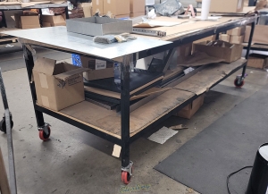 WORKBENCH ON CASTERS W  WOOD TOP 3 ft X 8 ft CONTENTS NOT INCLUDED-105