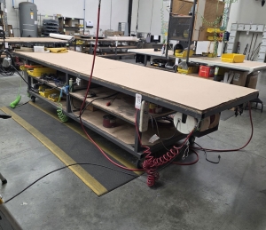 STEEL TABLE ON CASTERS W/ 14' X 4' PLYWOOD TOP, 37" TOP HT, CONTENTS NOT INCLUDED-173