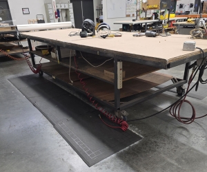 STEEL TABLE ON CASTERS W/ 14' X 5' PLYWOOD TOP, 37" TOP HT, CONTENTS NOT INCLUDED-177