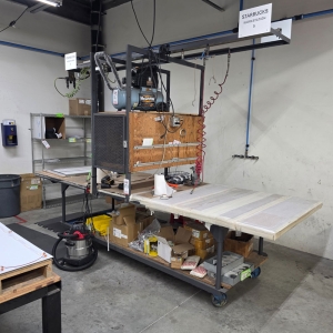 STEEL TABLE ON CASTERS W/ 12' X 4' WOOD TOP, 37" TOP HT, CENTER STORAGE, CONTENTS NOT INCLUDED-198