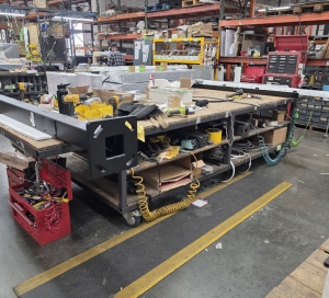 STEEL TABLE ON CASTERS W/ 14' X 5' WOOD TOP, 36" TOP HT, CONTENTS NOT INCLUDED-205