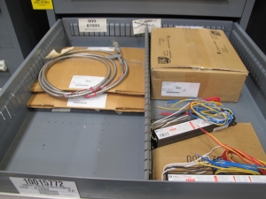 STANLEY VIDMAR CABINET, 11 DRAWER, TO INCLUDE: VOLT METERS, THERMOCOUPLE WIRE, BALLASTS, GROMMETS, ROLLERS, BLANK METERS, SUPPRESSORS. LOCATED AT W-50 . LOADING AND HANDLING FEE $25-377