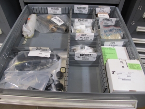 STANLEY VIDMAR CABINET, 8 DRAWER, TO INCLUDE: SCREEN FILTERS, METERING TUBES, TERMINAL WIRES, RELAYS, PRESSURE GAUGE, BRASS SHAFTS, ROTAMETERS, PINS, RINGS. LOCATED AT W-50 . LOADING AND HANDLING FEE $25-383