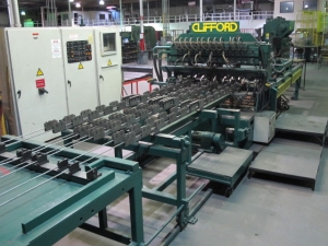 1999 CLIFFORD AUTOMATIC CNC MESH WELDING LINE, MODEL CLW12, 8MM-3MM LINE WIRE DIAMETER, 20 WIRE LINES, CROSSWIRE DIAMETER: 6MM, CROSSWIRE LENGTH: 1300 MM, LINEWIRE PITCH: INFINITELY VARIABLE FROM 10MM, CROSSWIRE FEED: SINGLE GAP TYPE MAGAZINE TOOLED FOR PRODUCING 2 MATS, SIDE BY SIDE, (10) WELDPRESSES, (20) BOTTOM ELECTRODES, (4) 125 KVA WELDING TRANSFORMERS, 120 CROSSWIRES MAX. SPEED, LINEAR MODEL QM12/25 PAILOUT, AUTOMATIC SHEET STACKER, WATER COOLING SYSTEM, MITSUISHI A1 CNC CONTROL, S/N 8874, SHEET STACKER, S/N 8979, (2) ENCLOSED CARTS FULL OF WELDING TIPS AND REALTED TOOLING INCLUDED WITH MACHINE-2