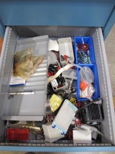 LISTA INDUSTRIAL WORK DESK, BUTCHER BLOCK TABLE TOP SHELF 48"L X 30"W, 4 DRAWER CABINET WITH CONTENTS TO INCLUDE: MISC. TEST CABLES AND WIRE, WIRE BRUSHES. LOADING & HANDLING $15-1673