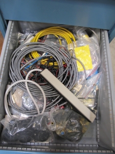 LISTA INDUSTRIAL WORK DESK, BUTCHER BLOCK TABLE TOP 48"L X 30"W, 4 DRAWER CABINET WITH CONTENTS TO INCLUDE: ELECTRIC CONNECTORS, CABLES, TEST WIRING . LOADING & HANDLING $15-1674