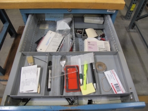 LISTA INDUSTRIAL WORK DESK, BUTCHER BLOCK TABLE TOP 48"L X 30"W, SHELF, 4 DRAWER CABINET WITH CONTENTS TO INCLUDE: MISC. OFFICE SUPPLIES, CABLES, AND EAR MUFFS. LOADING & HANDLING $15-1675