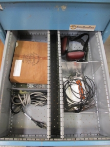 LISTA INDUSTRIAL WORK DESK, BUTCHER BLOCK TABLE TOP 48"L X 30"W, SHELF, 4 DRAWER CABINET WITH CONTENTS TO INCLUDE: MISC. OFFICE SUPPLIES, CABLES, AND EAR MUFFS. LOADING & HANDLING $15-1675