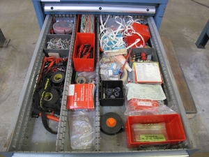 LISTA INDUSTRIAL WORK DESK, BUTCHER BLOCK TABLE TOP 60"L X 30"W, 5 DRAWER CABINET WITH CONTENTS TO INCLUDE: MISC. ELECTRICAL TAPE, ELECTRICAL TESTING WIRE AND TIPS, BRASS AND STEEL FITTINGS. LOADING & HANDLING $15-1690