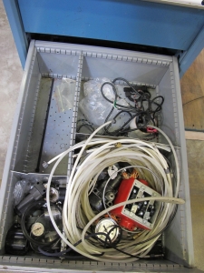 LISTA INDUSTRIAL WORK DESK, BUTCHER BLOCK TABLE TOP 60"L X 30"W, 5 DRAWER CABINET WITH CONTENTS TO INCLUDE: MISC. ELECTRICAL TAPE, ELECTRICAL TESTING WIRE AND TIPS, BRASS AND STEEL FITTINGS. LOADING & HANDLING $15-1690