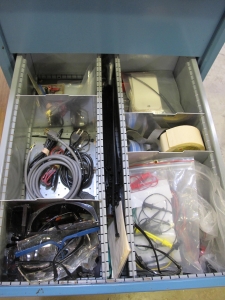 LISTA INDUSTRIAL WORK DESK, BUTCHER BLOCK TABLE TOP 48"L X 30"W, SHELF, 4 DRAWER CABINET WITH CONTENTS TO INCLUDE: MISC. OFFICE SUPPLIES, CABLES, SAFETY GLASSES, BRUSHES, ELECTRIC TESTING WIRE. LOADING & HANDLING $15-1691