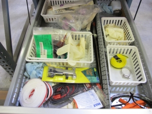 LISTA INDUSTRIAL WORK DESK, BUTCHER BLOCK TABLE TOP 60"L X 30"W, 5 DRAWER CABINET WITH CONTENTS TO INCLUDE: MISC. OFFICE SUPPLIES, EAR PLUGS, SAFETY GLASSES, ELECTRIC TEST WIRE, . LOADING & HANDLING $15-1693