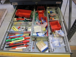 LISTA INDUSTRIAL WORK DESK, BUTCHER BLOCK TABLE TOP 60"L X 30"W, 5 DRAWER CABINET WITH CONTENTS TO INCLUDE: MISC. OFFICE SUPPLIES, TEST WIRE, EAR MUFFS. LOADING & HANDLING $15-1694