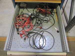 LISTA INDUSTRIAL WORK DESK, BUTCHER BLOCK TABLE TOP 60"L X 30"W, 5 DRAWER CABINET WITH CONTENTS TO INCLUDE: MISC. OFFICE SUPPLIES, TEST WIRE, EAR MUFFS. LOADING & HANDLING $15-1694