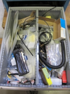 LISTA INDUSTRIAL WORK DESK, BUTCHER BLOCK TABLE TOP 60"L X 30"W, 5 DRAWER CABINET WITH CONTENTS TO INCLUDE: MISC. OFFICE SUPPLIES, TEST WIRE, EAR MUFFS. LOADING & HANDLING $15-1694