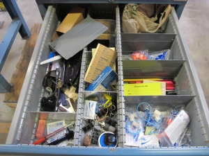 LISTA INDUSTRIAL WORK DESK, BUTCHER BLOCK TABLE TOP 48"L X 30"W, SHELF, 4 DRAWER CABINET WITH CONTENTS TO INCLUDE: EAR PLUGS, MISC. OFFICE SUPPLIES, WIRING, PRECISION SCREWDRIVERS, WATERPROOF RAINWEAR 3 PIECE SUIT. LOADING & HANDLING $15-1696