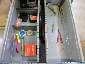 LISTA INDUSTRIAL WORK DESK, BUTCHER BLOCK TABLE TOP 48"L X 30"W, SHELF, 4 DRAWER CABINET WITH CONTENTS TO INCLUDE: EAR PLUGS, MISC. OFFICE SUPPLIES, WIRING, PRECISION SCREWDRIVERS, WATERPROOF RAINWEAR 3 PIECE SUIT. LOADING & HANDLING $15-1696