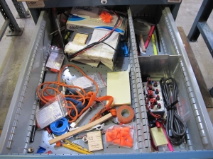 LISTA INDUSTRIAL WORK DESK, BUTCHER BLOCK TABLE TOP 48"L X 30"W, 4 DRAWER CABINET WITH CONTENTS TO INCLUDE: EAR PLUGS, MISC. OFFICE SUPPLIES, WIRING, BRUSH, EAR MUFFS. LOADING & HANDLING $15-1698