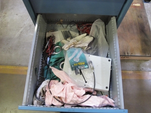 LISTA INDUSTRIAL WORK DESK, BUTCHER BLOCK TABLE TOP 48"L X 30"W, 4 DRAWER CABINET WITH CONTENTS TO INCLUDE: EAR PLUGS, MISC. OFFICE SUPPLIES, WIRING, BRUSH, EAR MUFFS. LOADING & HANDLING $15-1698