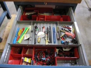 LISTA INDUSTRIAL WORK DESK, BUTCHER BLOCK TABLE TOP 48"L X 30"W, 4 DRAWER CABINET WITH CONTENTS TO INCLUDE: EAR PLUGS, MISC. OFFICE SUPPLIES, TEST WIRING, TUBING. LOADING & HANDLING $15-1699