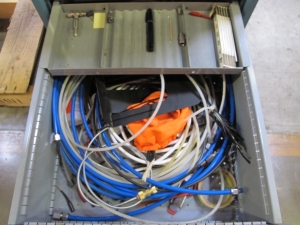 LISTA INDUSTRIAL WORK DESK, BUTCHER BLOCK TABLE TOP 48"L X 30"W, 4 DRAWER CABINET WITH CONTENTS TO INCLUDE: EAR PLUGS, MISC. OFFICE SUPPLIES, TEST WIRING, TUBING. LOADING & HANDLING $15-1699